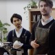 Two baristas behind coffee machines