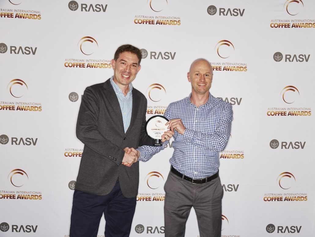 Man receiving an award for the Australian International Coffee Awards