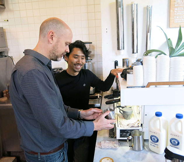 Barista smiling while making coffee