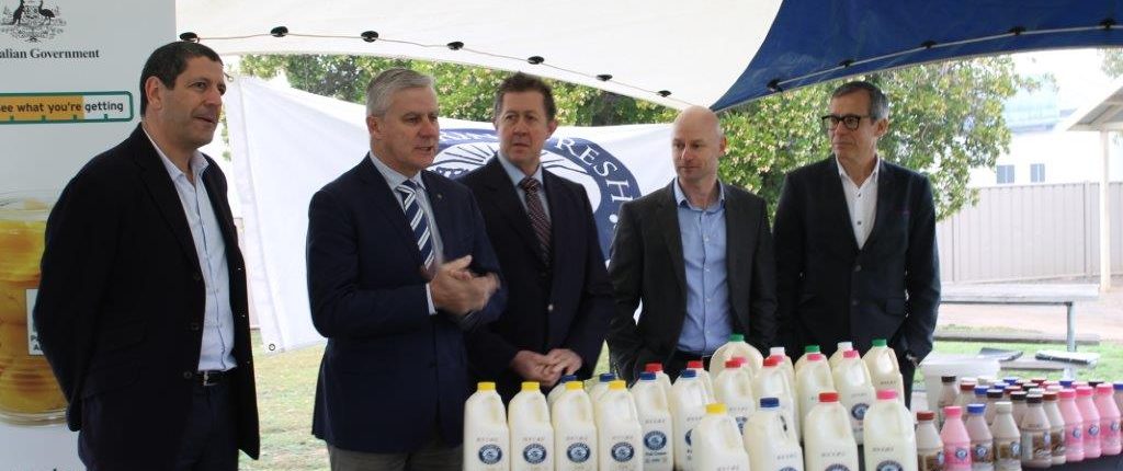 Panel standing behind a table of Riverina Fresh milk