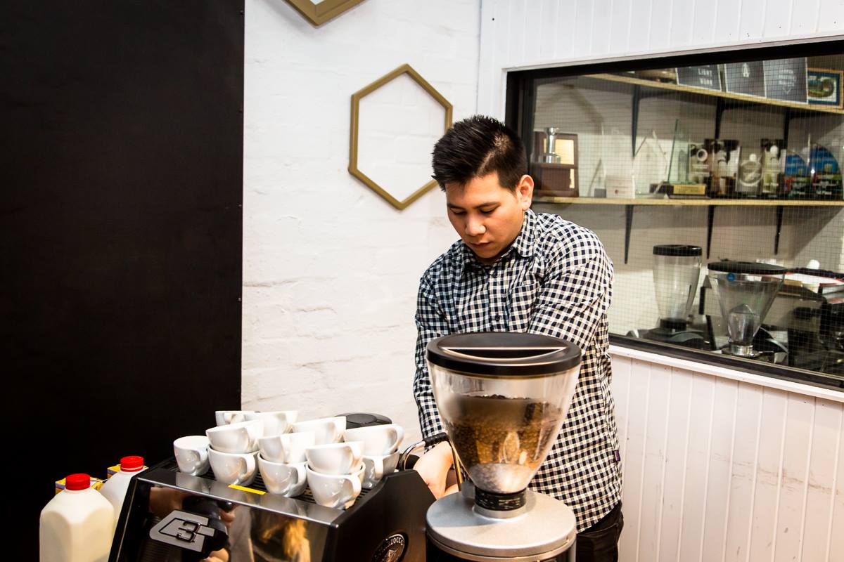 Man standing behind coffee machine