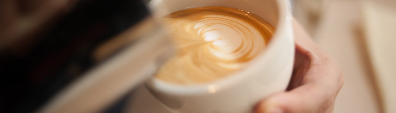 Two baristas in aprons